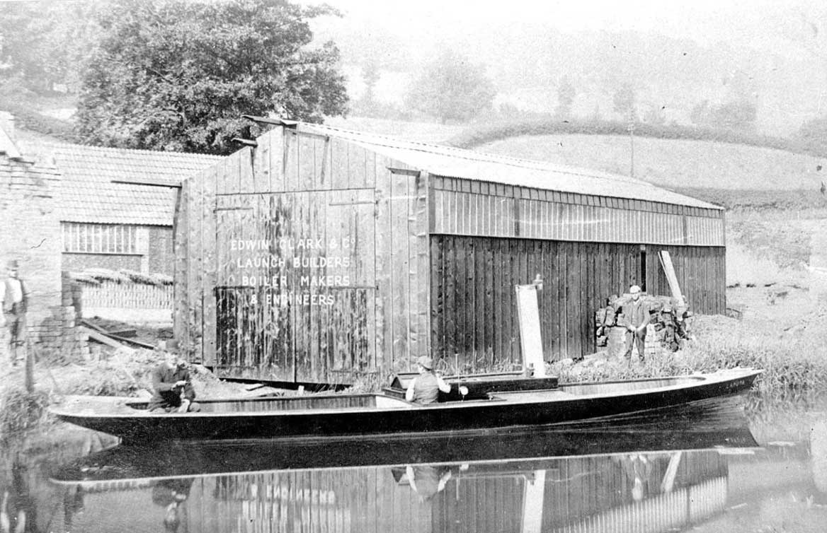 A steamboat in front of the shed where it was built. (Heritage Steamboat Trust)