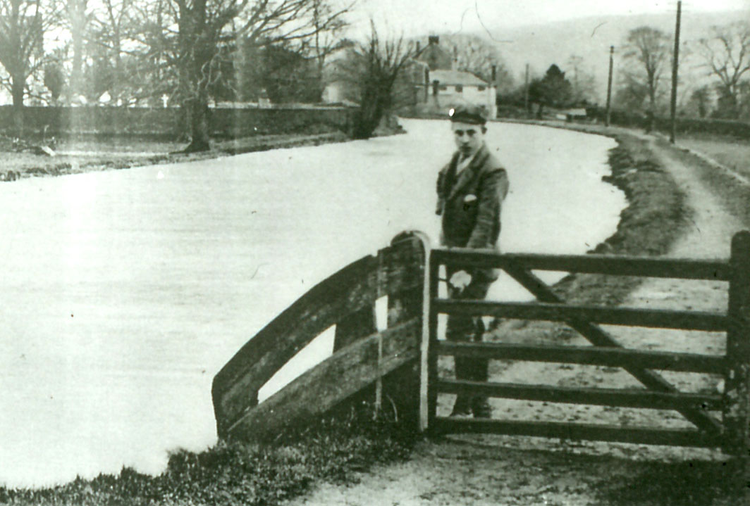 Boy by towpath gate (Stanley Gardiner Collection)